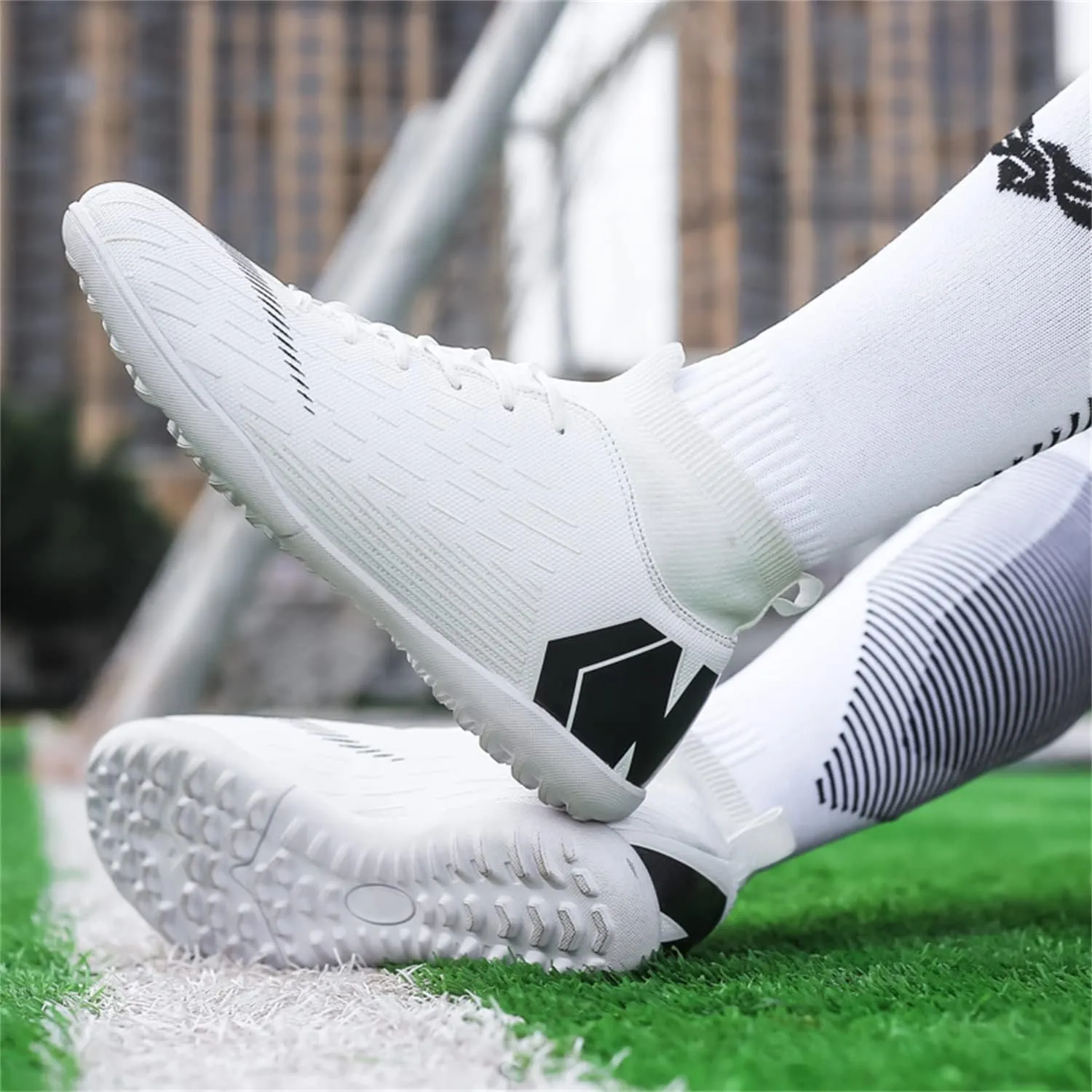 Unisex soccer sneakers are light, breathable, non-slip and shock-absorbing, and The youth high-top indoor lawn training hard bottom TF/AG.